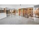 Open concept living room featuring cinder block walls and a terrazzo floor at 11240 6Th E St, Treasure Island, FL 33706