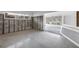 Living room with large windows, cinder block walls, and a terrazzo floor in need of repair at 11240 6Th E St, Treasure Island, FL 33706