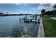 Scenic waterfront view with a wooden dock, providing access to the water and enhancing the property's appeal at 11240 6Th E St, Treasure Island, FL 33706