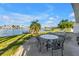 Waterfront patio area with outdoor seating and picturesque views of the water, ideal for relaxation and entertaining at 11240 6Th E St, Treasure Island, FL 33706