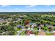 Aerial view of residential neighborhood, featuring well-kept homes near a scenic pond and lush green spaces at 11550 Wellman Dr, Riverview, FL 33578