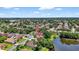 Residential neighborhood aerial view featuring homes with lake access and mature trees at 11550 Wellman Dr, Riverview, FL 33578