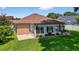 Landscaped backyard with a sunroom extension, perfect for outdoor living and entertaining at 11550 Wellman Dr, Riverview, FL 33578