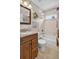 Bathroom with a wood vanity, mirror, shower with tub and a window at 11550 Wellman Dr, Riverview, FL 33578