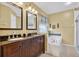 Bathroom featuring a double sink vanity, tub, and mosaic tile accents at 11550 Wellman Dr, Riverview, FL 33578
