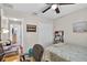 Comfortable bedroom featuring a bed, desk with a chair, and neutral-toned walls at 11550 Wellman Dr, Riverview, FL 33578