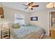 Well-lit bedroom with two twin beds, patterned bedding, and a ceiling fan at 11550 Wellman Dr, Riverview, FL 33578