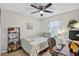 Inviting bedroom features a bed, desk, shelves, and a large window with sheer curtains at 11550 Wellman Dr, Riverview, FL 33578
