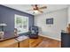 Bedroom with hardwood floors, ceiling fan and bright natural light streaming through window at 11550 Wellman Dr, Riverview, FL 33578