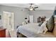 Bright bedroom features a large bed, carpet, and a view of an ensuite bath with a glass-enclosed shower at 11550 Wellman Dr, Riverview, FL 33578