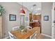 A quaint breakfast nook featuring a square wooden table and an open view to the kitchen at 11550 Wellman Dr, Riverview, FL 33578