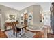 Elegant dining room with wood floors and a view of the kitchen, with plenty of natural light at 11550 Wellman Dr, Riverview, FL 33578