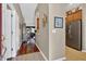 Interior shot of home's entryway shows hardwood floors and seamless transition to kitchen at 11550 Wellman Dr, Riverview, FL 33578