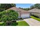 Well-maintained home with green lawn, trimmed shrubs, and a two-car garage presenting an inviting curb appeal at 11550 Wellman Dr, Riverview, FL 33578