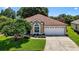 Charming home with a well-manicured lawn, mature landscaping, and a two-car garage enhancing its curb appeal at 11550 Wellman Dr, Riverview, FL 33578