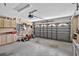 Spacious two car garage featuring storage cabinets, tools and a garage door with windows at 11550 Wellman Dr, Riverview, FL 33578