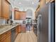 Spacious kitchen featuring stainless steel appliances and dark wood cabinets at 11550 Wellman Dr, Riverview, FL 33578