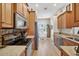 Galley kitchen with stainless appliances, granite counters, and adjacent dining area bathed in natural light at 11550 Wellman Dr, Riverview, FL 33578