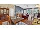 Open concept living area with dining space, hardwood floors, a vaulted ceiling, and ample natural light at 11550 Wellman Dr, Riverview, FL 33578