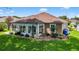 Spacious sunroom with large windows and well-maintained landscaping at 11550 Wellman Dr, Riverview, FL 33578
