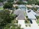 Aerial view of a home with well-maintained landscaping and a three-car garage at 11610 Grove Arcade Dr, Riverview, FL 33569