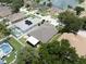 Aerial view of a home near a lake, with lush landscaping, a patio, and nearby amenities at 11610 Grove Arcade Dr, Riverview, FL 33569