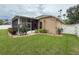 Beautiful home with a screened-in porch, manicured lawn, and lush landscaping at 11610 Grove Arcade Dr, Riverview, FL 33569