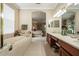 Bright bathroom view into the Primary bedroom with a tub and dual sinks at 11610 Grove Arcade Dr, Riverview, FL 33569