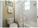 Clean bathroom with a tiled shower-tub combination and decorative shower curtain adding a touch of style at 11610 Grove Arcade Dr, Riverview, FL 33569