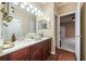 Elegant bathroom with a dual-sink vanity, wood cabinetry, and decorative accents, adding a touch of luxury at 11610 Grove Arcade Dr, Riverview, FL 33569