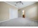 Bright bedroom features neutral walls, carpet, white trim, and a ceiling fan at 11610 Grove Arcade Dr, Riverview, FL 33569