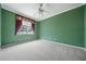 Bright bedroom with green walls, plush carpeting, and a window with decorative valance for a cozy appeal at 11610 Grove Arcade Dr, Riverview, FL 33569