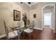 Elegant dining area features a glass table, ornate chairs, and artistic décor at 11610 Grove Arcade Dr, Riverview, FL 33569