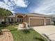 Charming single-story home with a well-manicured lawn, mature trees and a three car garage at 11610 Grove Arcade Dr, Riverview, FL 33569