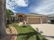 Charming single-story home with a well-manicured lawn, mature trees and a three car garage at 11610 Grove Arcade Dr, Riverview, FL 33569