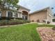Charming home exterior with a well-manicured front yard, water fountain, and inviting entryway at 11610 Grove Arcade Dr, Riverview, FL 33569