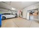 Spacious two-car garage with ample storage, epoxy flooring, and utility shelving at 11610 Grove Arcade Dr, Riverview, FL 33569