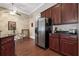Bright kitchen boasts stainless steel appliances, wooden cabinetry, and a spacious dining area at 11610 Grove Arcade Dr, Riverview, FL 33569
