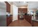 Bright kitchen boasts stainless steel appliances, wooden cabinetry, and granite countertops at 11610 Grove Arcade Dr, Riverview, FL 33569