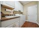 Functional laundry room with white cabinets, sink, and modern washer and dryer at 11610 Grove Arcade Dr, Riverview, FL 33569
