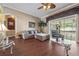Inviting living room with hardwood floors, comfortable seating, and access to the screened porch at 11610 Grove Arcade Dr, Riverview, FL 33569