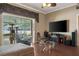 Open living room with a large television, ceiling fan, and access to the outdoors at 11610 Grove Arcade Dr, Riverview, FL 33569