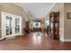 Expansive living room with hardwood floors, large windows, and elegant furnishings at 11610 Grove Arcade Dr, Riverview, FL 33569