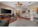 Open-concept living room with wood floors and views into the kitchen and dining areas at 11610 Grove Arcade Dr, Riverview, FL 33569