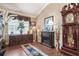 Cozy den with a window, a fireplace, and a beautiful antique grandfather clock at 11610 Grove Arcade Dr, Riverview, FL 33569