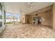 Large screened patio with brick flooring, ceiling fans, and access to the outdoors, ideal for enjoying the weather at 11610 Grove Arcade Dr, Riverview, FL 33569