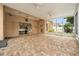 Extensive screened patio with stylish brick flooring and garden views, creating an exceptional outdoor living space at 11610 Grove Arcade Dr, Riverview, FL 33569