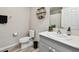 Well-lit bathroom featuring modern fixtures, a vanity with a white countertop, and stylish decor at 13027 Pennybrook Dr, Riverview, FL 33579