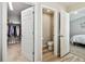 Bathroom leading to the walk-in closet and powder room, providing convenience and functionality at 13027 Pennybrook Dr, Riverview, FL 33579