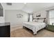Spacious bedroom featuring plush carpeting, a large window, and a comfortable bed with white linens at 13027 Pennybrook Dr, Riverview, FL 33579